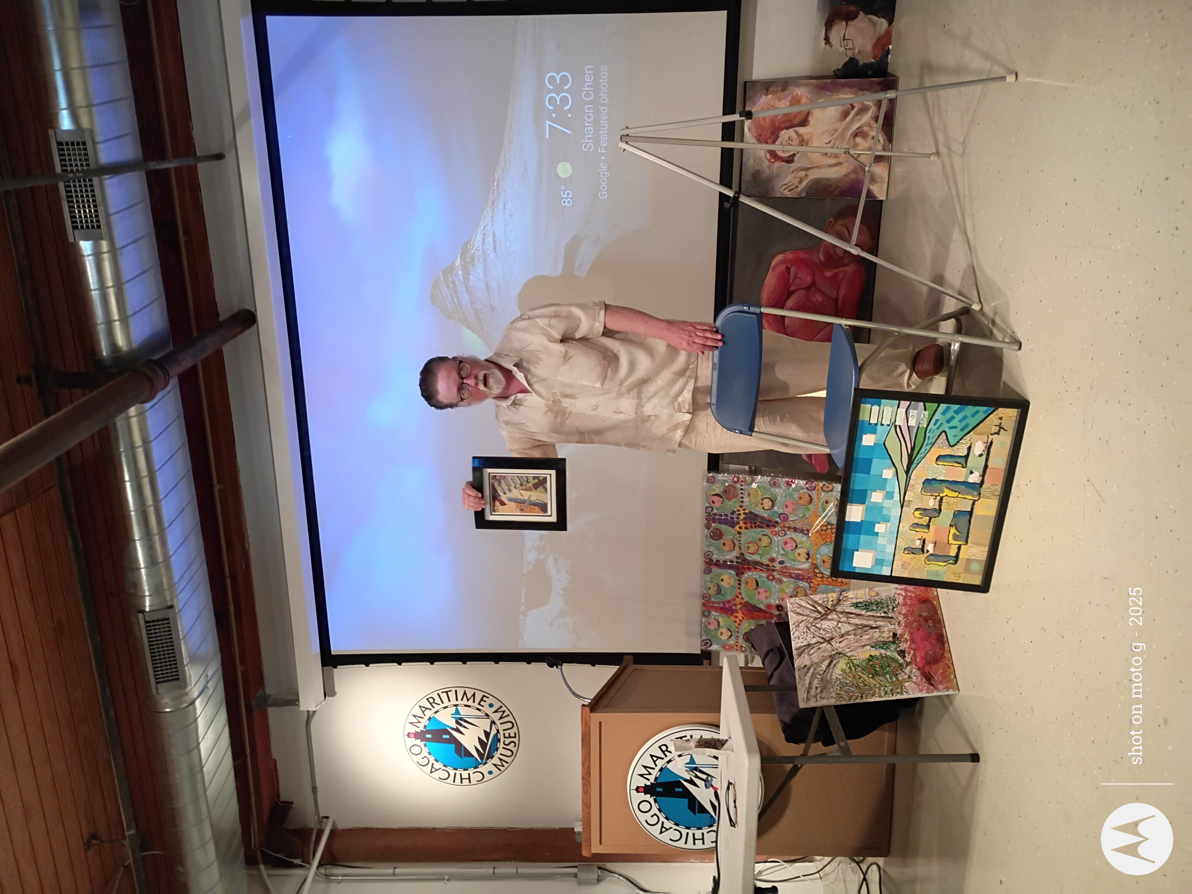 Art Salon artist presenting framed artwork
