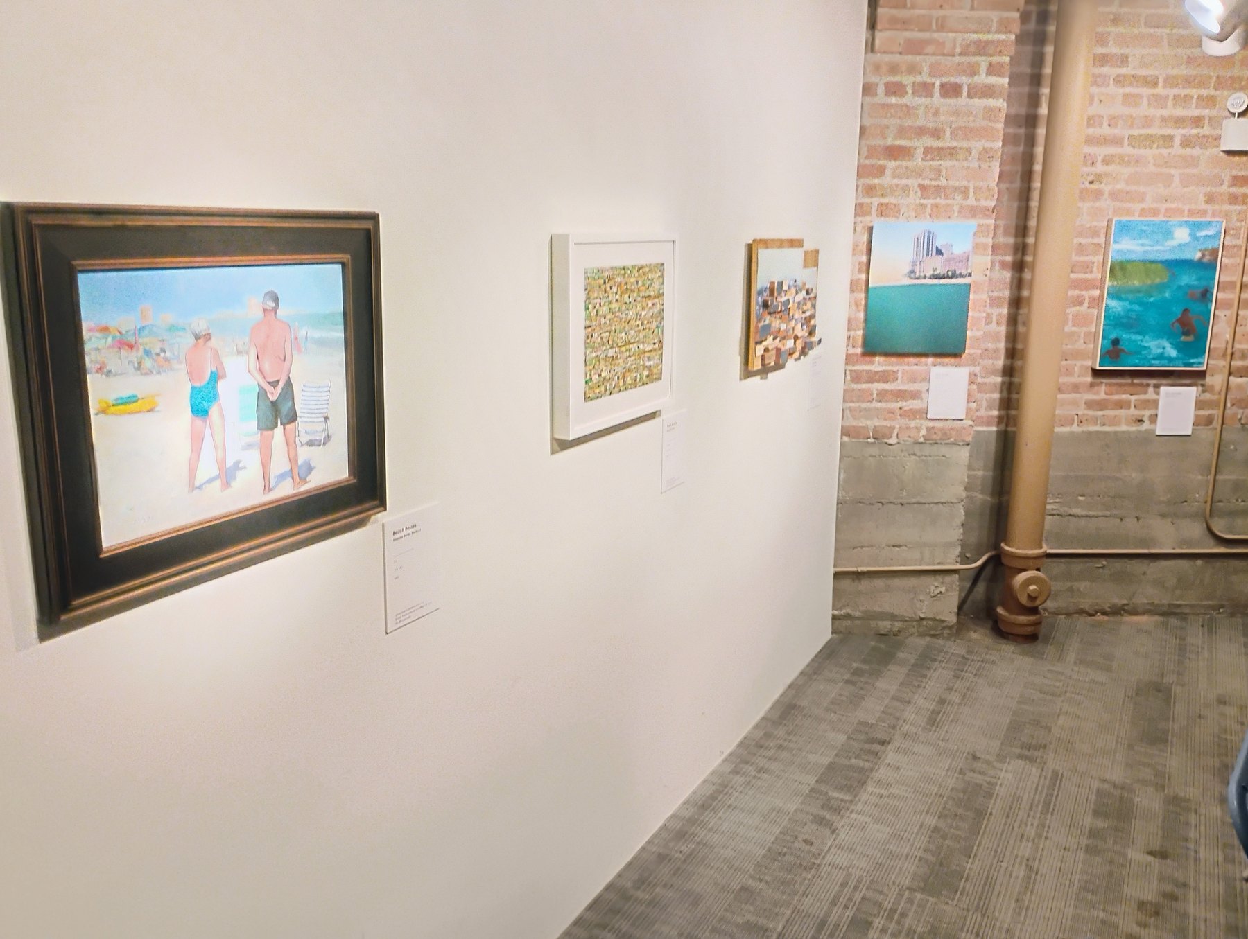 Big Shoulders, Wet Feet exhibition wall with framed artworks