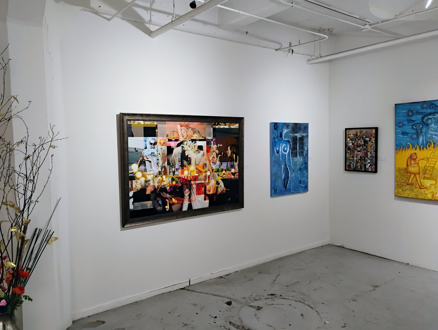 Collective Narratives exhibition wall with framed works