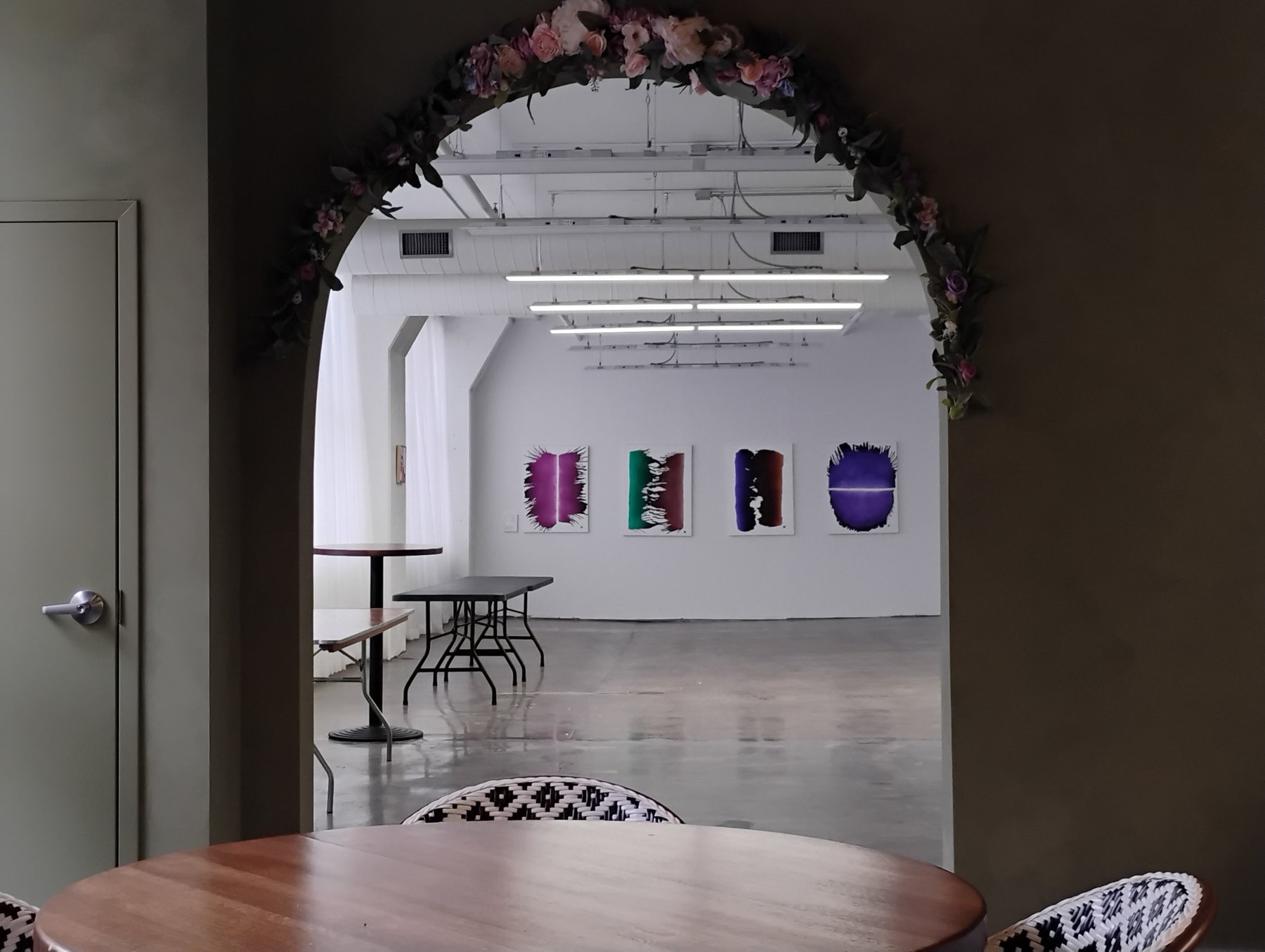 Human Nature gallery view through floral archway